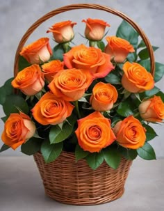 a basket filled with orange roses on top of a table