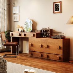 an open book is sitting on top of a dresser in a room with wooden floors