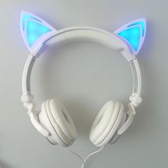 a white headphone with blue light up ears and cat ears on the top of it