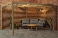 an outdoor living area with two couches and a table in front of a brick wall