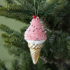 an ice cream cone ornament hanging from a christmas tree