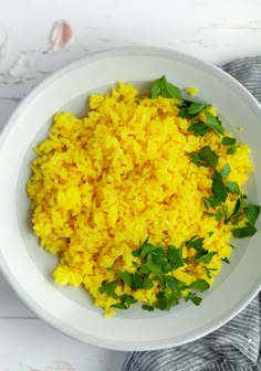 rice and cilantro on a white plate next to parsley