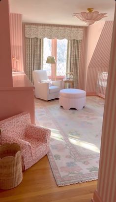 a living room with pink walls and furniture