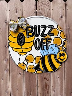 a sign that says buzzz off with a bee and honeycombs on it