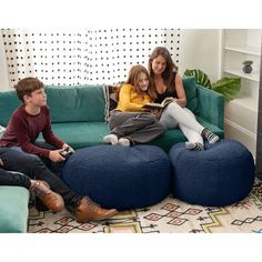 three people sitting on a couch with a blue bean bag