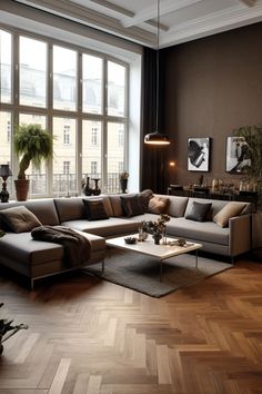 a living room filled with lots of furniture next to a large window and potted plants