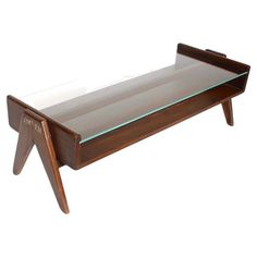 a glass and wood coffee table with an upside down shelf