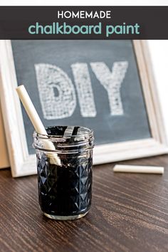 homemade chalkboard paint in a glass jar with a white straw sticking out of it