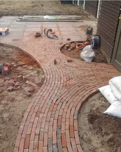 a brick walkway is being built in the yard