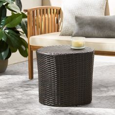 a wicker table sitting on top of a rug next to a couch