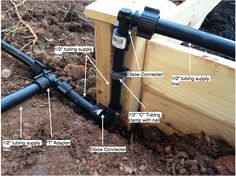 the parts of a garden hose attached to a wooden box in the ground with soil surrounding it