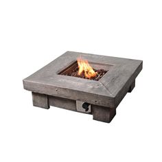 a concrete fire pit with flames burning in it