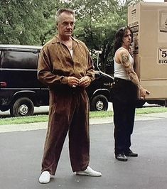 two people standing in front of a moving truck