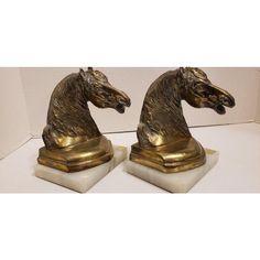 pair of brass horse head bookends on marble bases