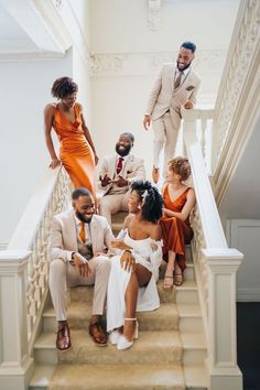 a group of people that are sitting on some stairs in front of a man and woman