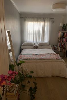 a bed sitting in a bedroom next to a window