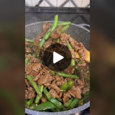 stir fry with beef and green beans in a wok on the stove, ready to be cooked