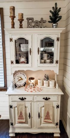 a white hutch with christmas decorations on it