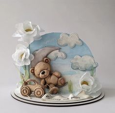 a teddy bear sitting on top of a cake