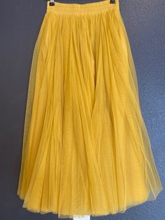 yellow tulle skirt wedding party vocation skirt size M  Details :  Color: yellow Size: M  Elastic waist  Material: Tulle lining inside  Measurements: *Waist: 12 inches across lay flat ( 24 inches around); can stretch to 19 inches wide (38 inches around). *Skirt length: 32 inches long Weight:  Appropriate 1 lb 5oz Care: Hand wash/Dry clean * Model's height is 5'7'' and waist is 28 inches, and is wearing size M  ---------------------------------------- Yellow Tulle Skirt, Tulle Skirt Wedding, White Tulle Skirt, Rainbow Skirt, Dance Skirt, White Tulle, Cashmere Scarf, Skirt Length, Tulle Skirt