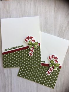 two christmas cards with candy canes on them, one is white and the other is green