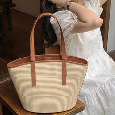 Add a summer-inspired touch to your accessories edit with this straw bucket tote bag. Woven from straw with leather trimmings, this handbag makes us look forward to summer and escapism. It comes with an open top and is roomy enough for all your essentials. Easy-to-wear wardrobe staples that combine classic and contemporary styles.Width (cm): 28 cmHeight (cm): 16 Color: Light brownInterior Material: Polyester CottonMaterial_bag: StrawBagType: Handbag & Shoulder bagBag Length: 28 cm French Baskets, Bucket Tote Bag, Bucket Tote, Basket Tote, Straw Bags, How To Make Handbags, Open Top, Color Light, Wardrobe Staples