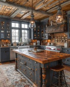 an old fashioned kitchen with wooden floors and blue cabinets, wood ceilinging, and two pendant lights hanging from the ceiling