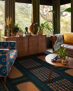 a living room filled with lots of furniture and plants on top of it's windowsill