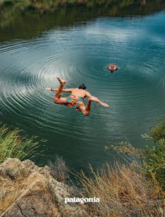 a man is swimming in the water with two other people floating on top of him