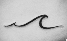 a black and white photo of a wave tattoo