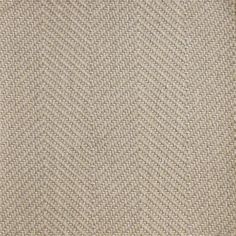 a close up view of a beige and grey area rug with herringbones on it