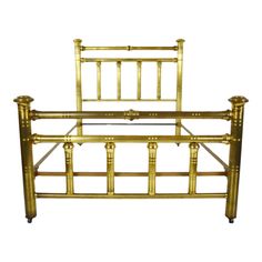 a gold metal bed frame with wooden posts