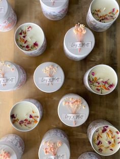 several cups filled with different types of flowers