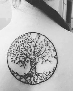 a woman with a tree tattoo on her back