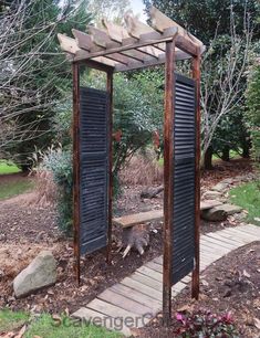 an outdoor wooden structure with black shutters and wood walkway leading up to the entrance