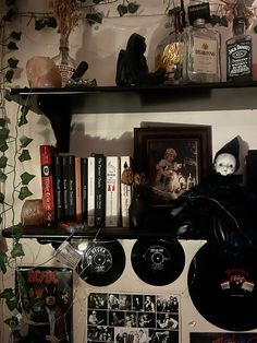 a shelf filled with lots of halloween decorations and books on top of it's shelves