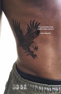 the back of a man's stomach with an eagle tattoo on it