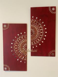 two pieces of art hanging on the wall next to each other with gold and red designs