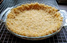 an uncooked pie sitting on top of a cooling rack