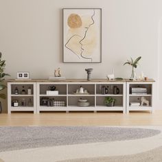 a living room with a large painting on the wall next to a book shelf filled with books