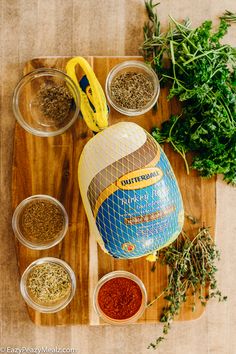 spices and herbs are on a cutting board