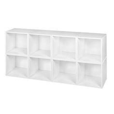 a white shelf with six cubbys on it