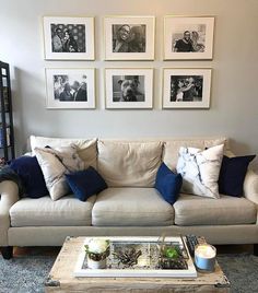 a living room filled with furniture and pictures on the wall above it's coffee table