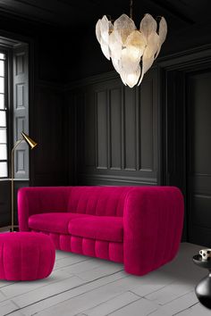 a living room with black walls and pink furniture