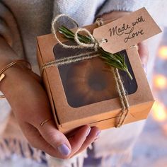 a person holding a box with some kind of food in it