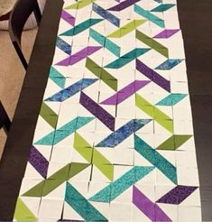 a table that has some very pretty quilts on it