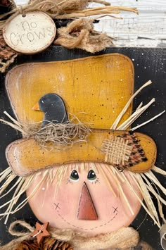 a scarecrow with a hat and boots on it's head is sitting next to some pine cones