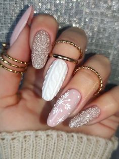 long acrylic nails with gold glitter, white sweater texture, and snowflakes