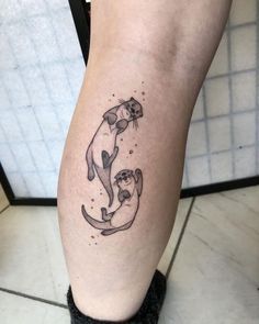 two cats sitting on top of each other in the shape of a crescent moon tattoo