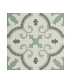 a green and white tile with an ornate design